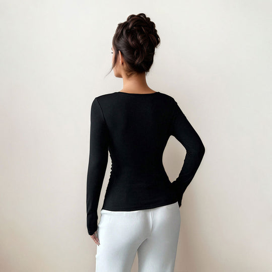 Damen figurbetontes Langarmshirt mit asymmetrischem Ausschnitt und dekorativer Brosche Eichborn Berlin