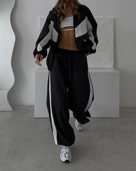 Damen sportives Zweiteiler-Set aus Oversize-Trackjacke mit Reißverschluss und weitem Bundfalten-Hose Eichborn Berlin