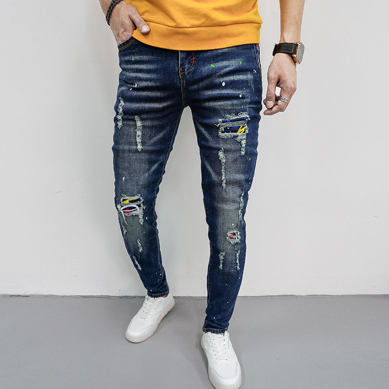 Herren Skinny Fit Jeans mit kreativen Farbklecksen und Rissdesign EB