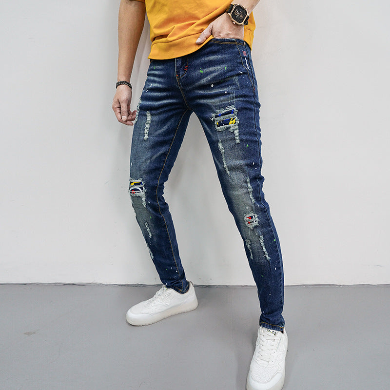Herren Skinny Fit Jeans mit kreativen Farbklecksen und Rissdesign EB