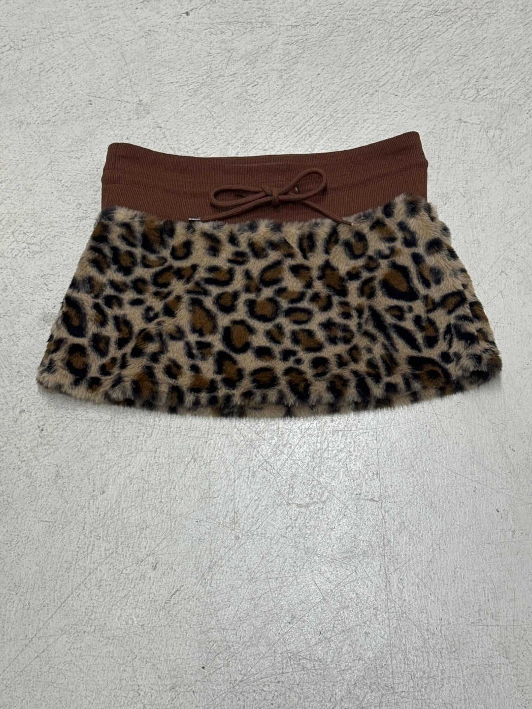 Damen eleganter Minirock aus fellartigem Material mit Modellknopf und Taillenband EB